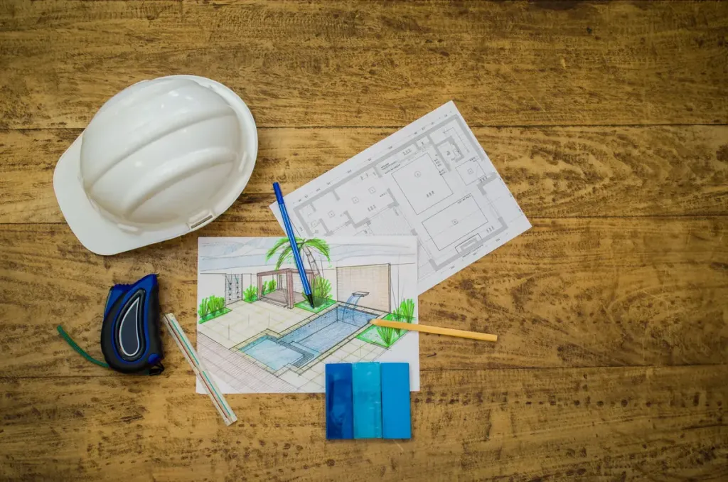 plans architecturaux et outils d'architecte pour le chantier d'une piscine